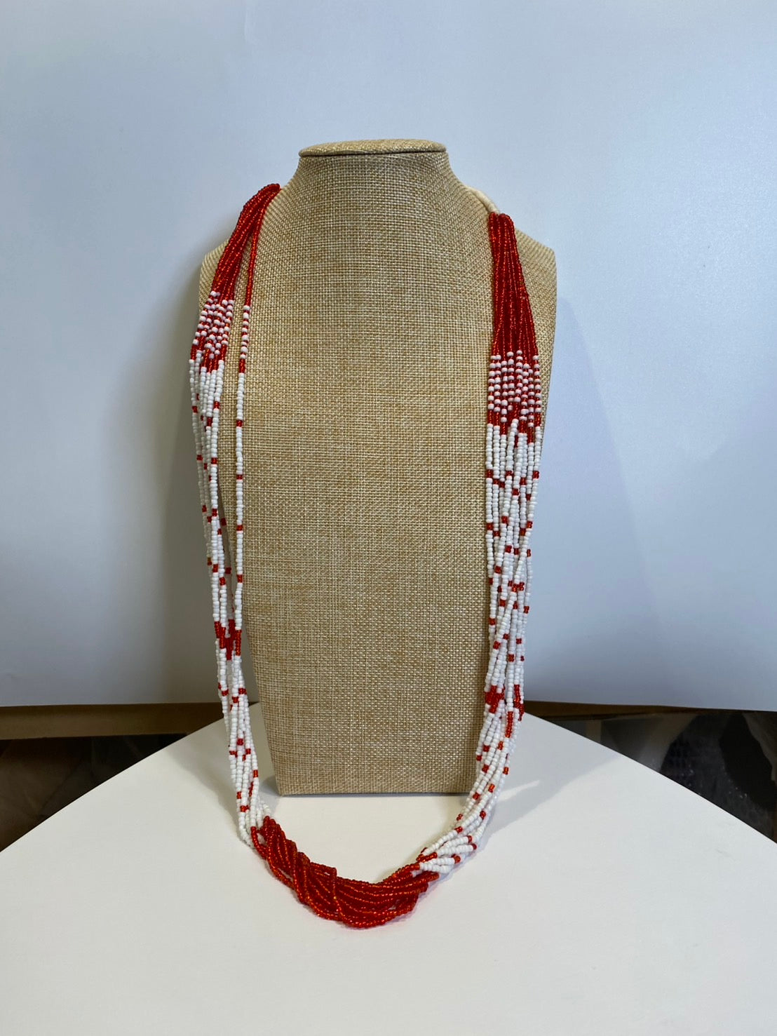 赤と白の長いネックレス。
