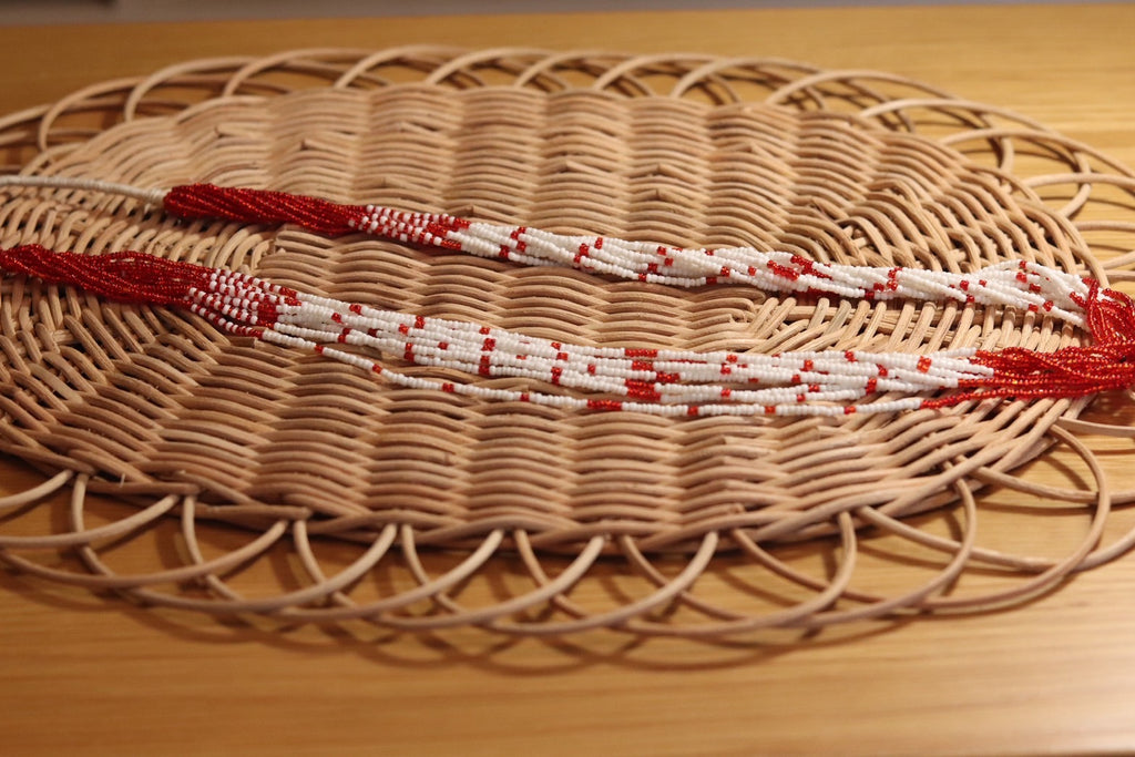 赤と白の長いネックレス。